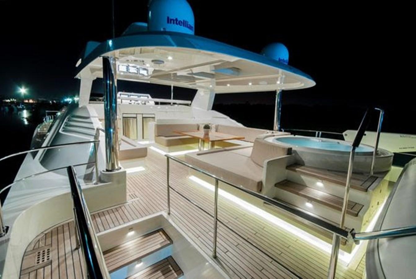 a large white building with a blue roof at night aboard 2024 MCP 106 LE Yacht for Sale