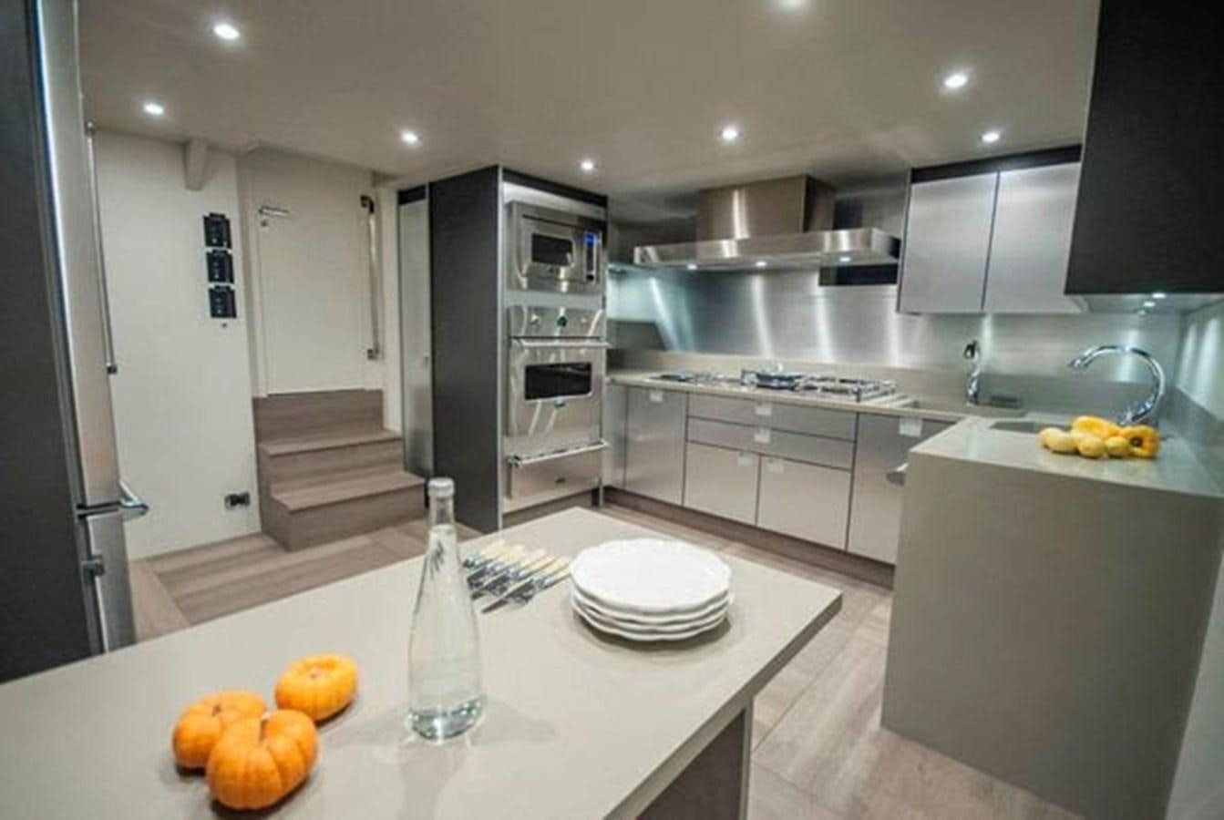 a kitchen with white cabinets aboard 2024 MCP 106 LE Yacht for Sale