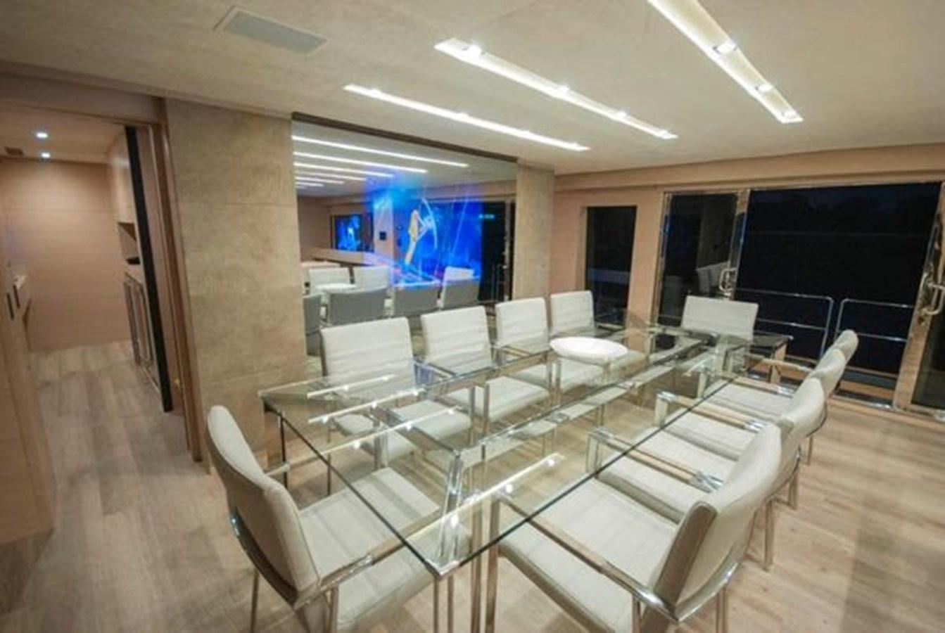 a room with tables and chairs aboard 2024 MCP 106 LE Yacht for Sale