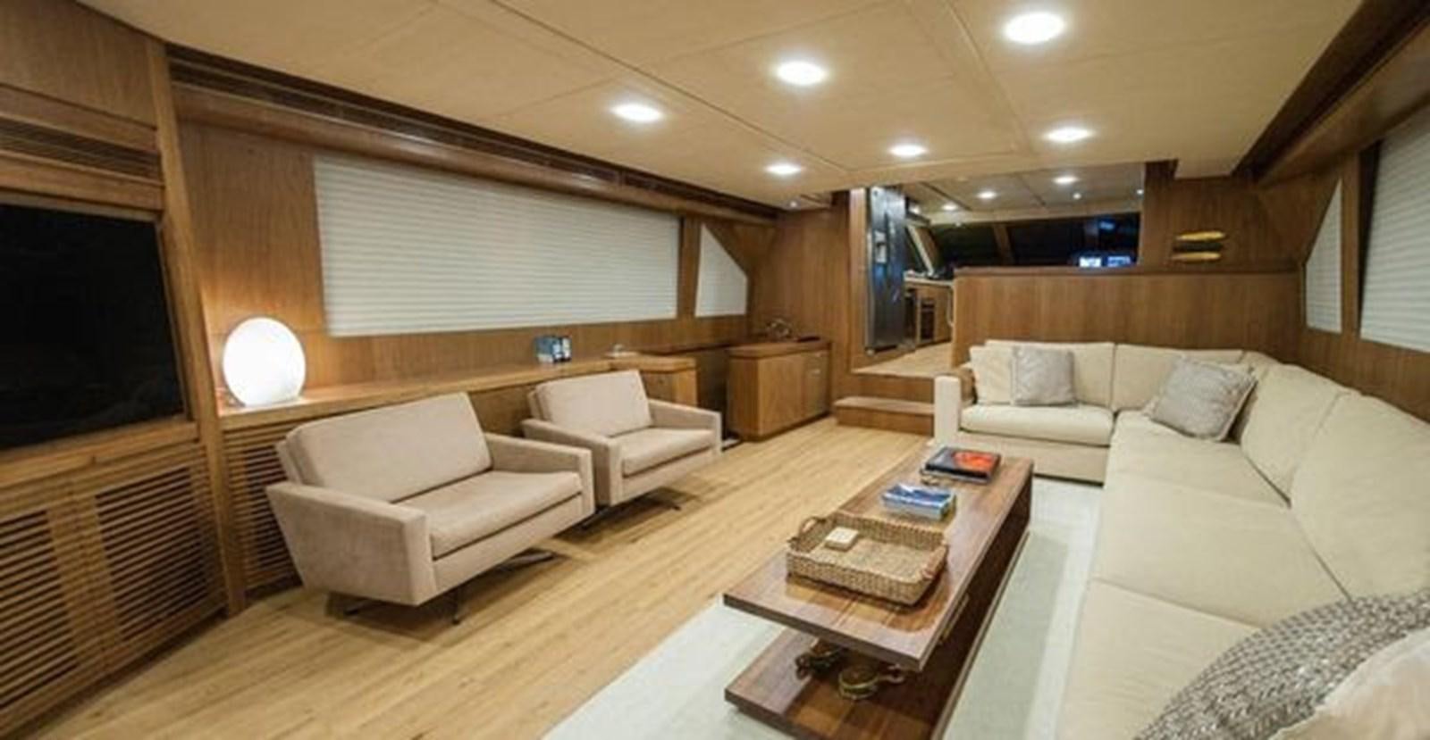 a living room with a couch and a coffee table aboard 2024 MCP 76 MY Yacht for Sale