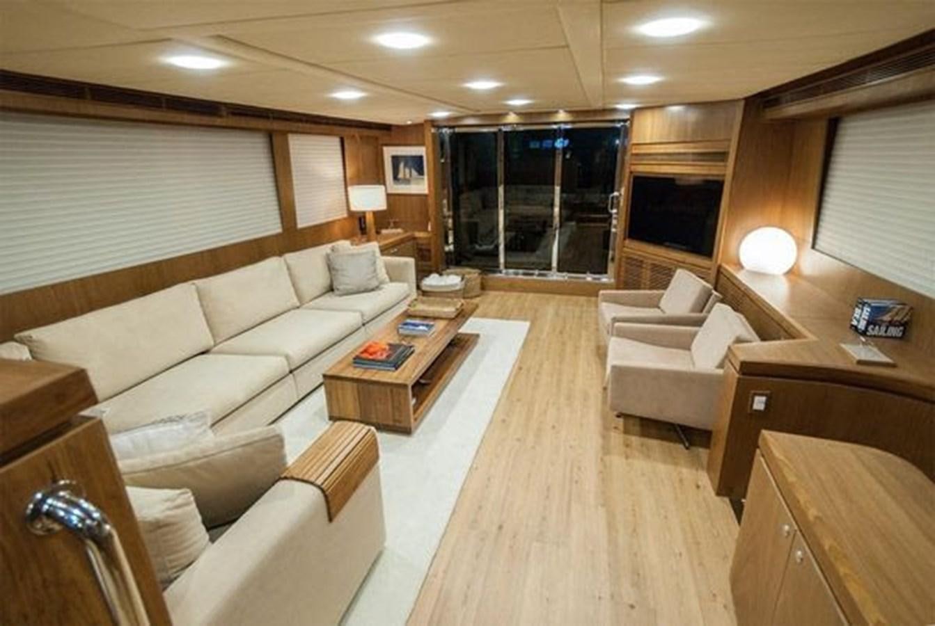 a living room with a couch and a coffee table aboard 2024 MCP 76 MY Yacht for Sale