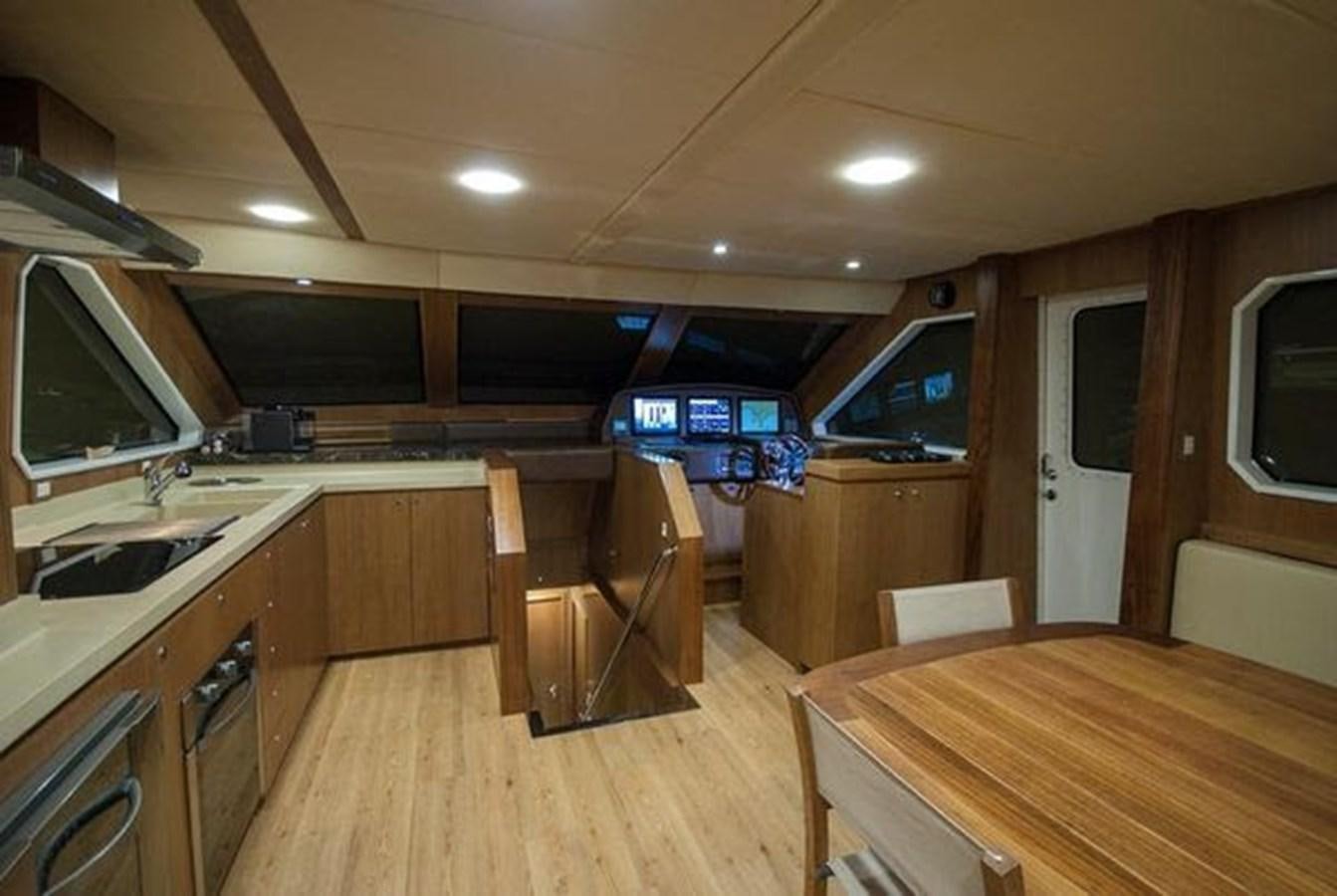 a kitchen with a wood floor aboard 2024 MCP 76 MY Yacht for Sale