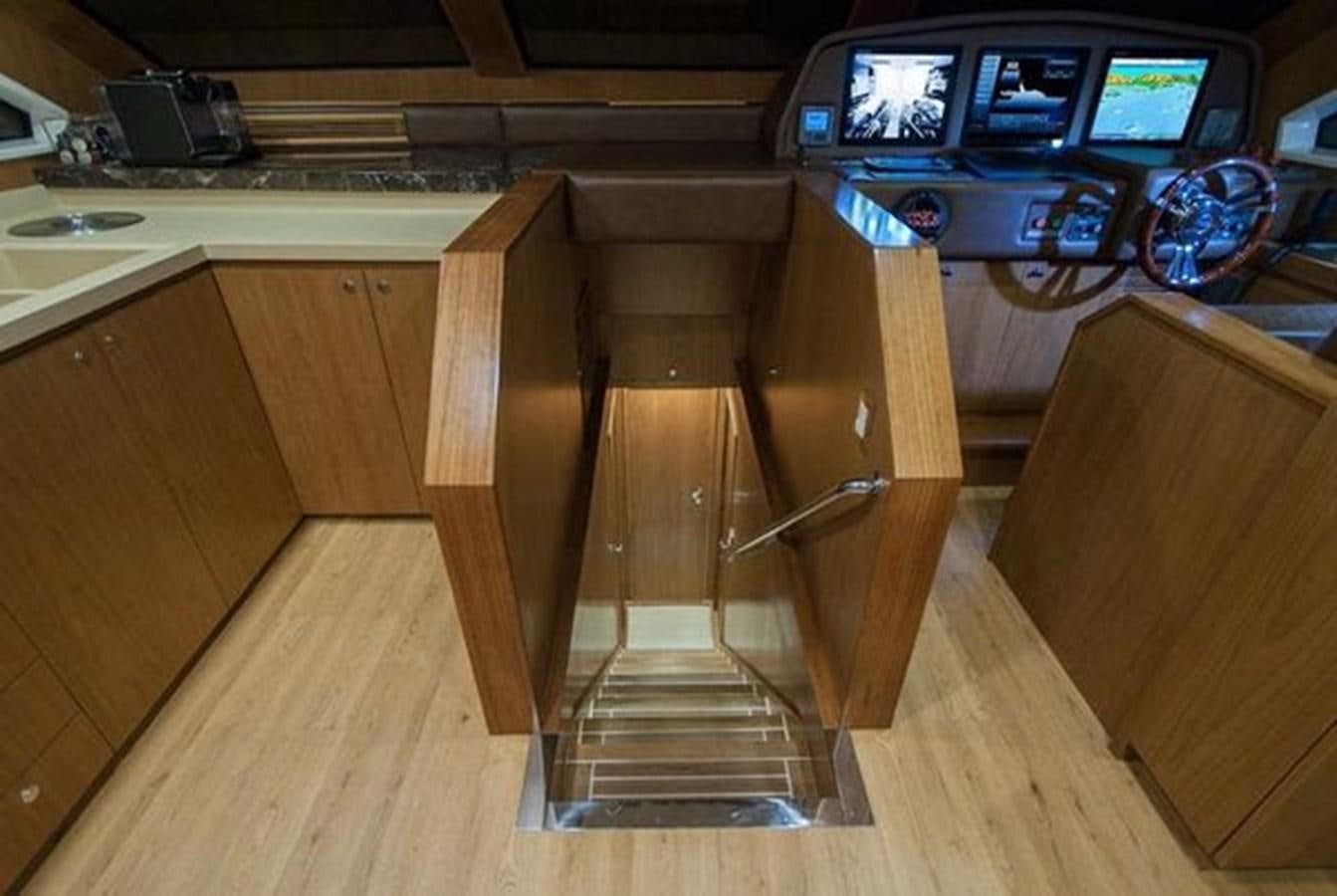 a wooden cabinet in a kitchen aboard 2024 MCP 76 MY Yacht for Sale