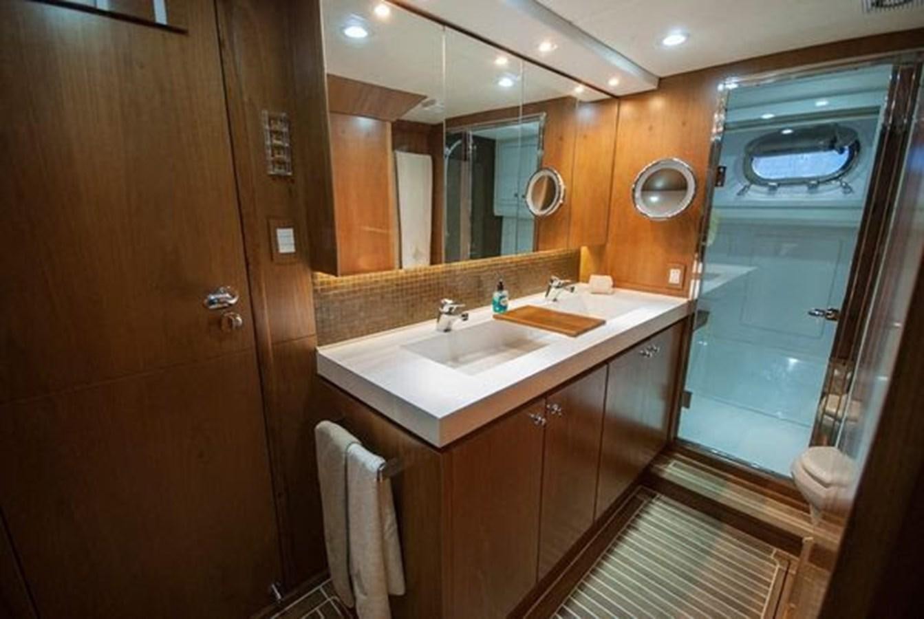 a bathroom with a sink and a mirror aboard 2024 MCP 76 MY Yacht for Sale