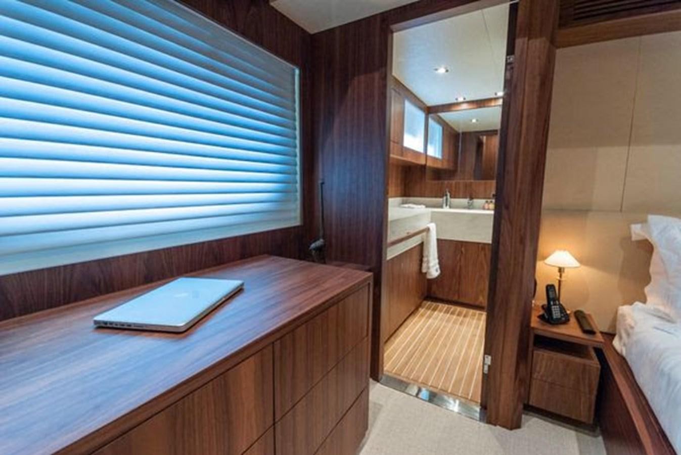 a hotel room with a bed and a desk aboard 2024 MCP 76 MY Yacht for Sale