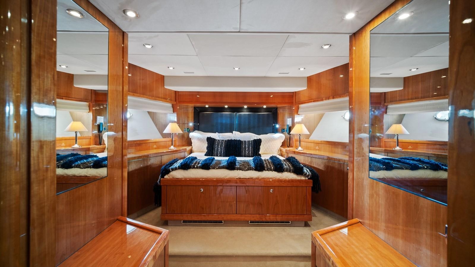 a bedroom with a wood bed aboard GBXSK04137L607 Yacht for Sale