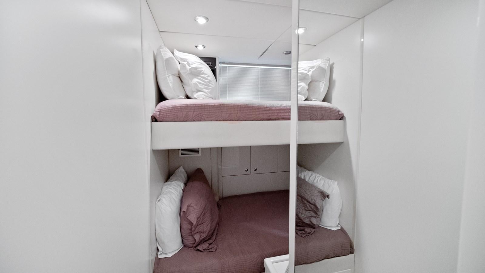 a person lying on a bed aboard GBXSK04137L607 Yacht for Sale
