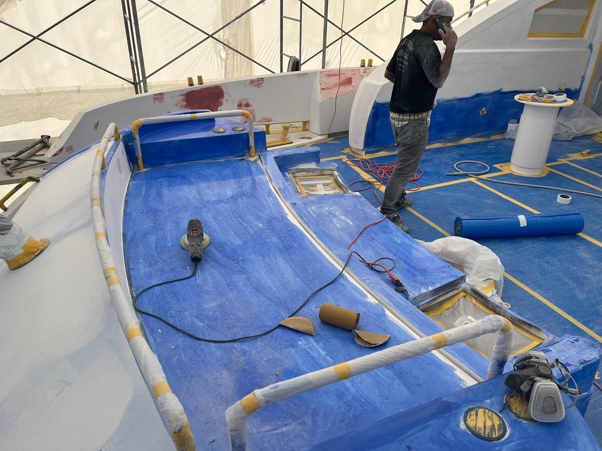 a person standing next to a large blue machine aboard GBXSK04137L607 Yacht for Sale