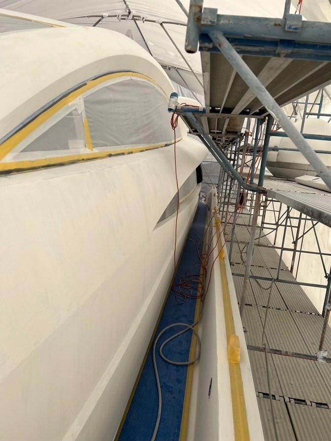a boat with a yellow and blue sail aboard GBXSK04137L607 Yacht for Sale