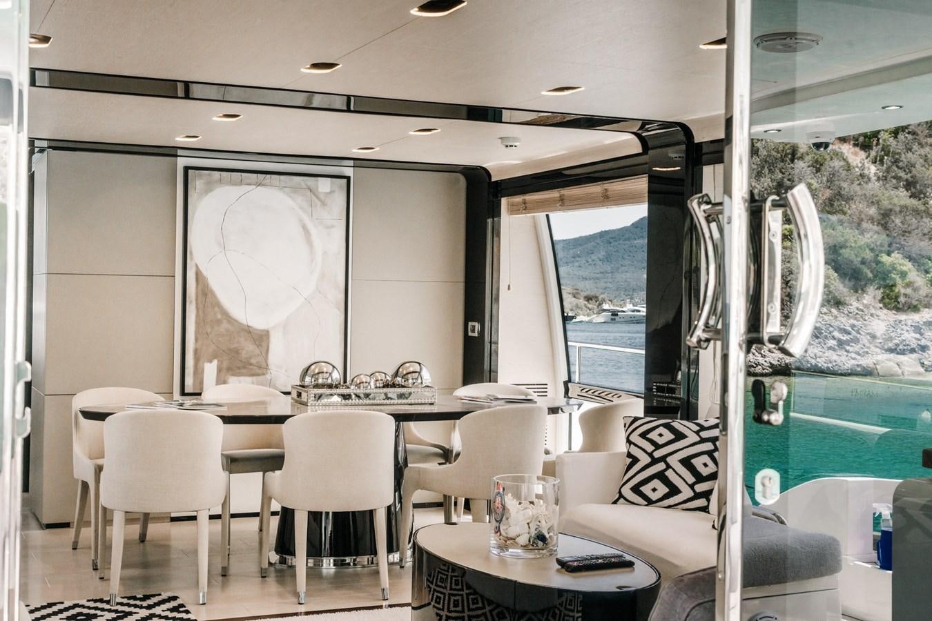 a room with a table chairs and a window aboard AZIMUT 88 DELETE Yacht for Sale