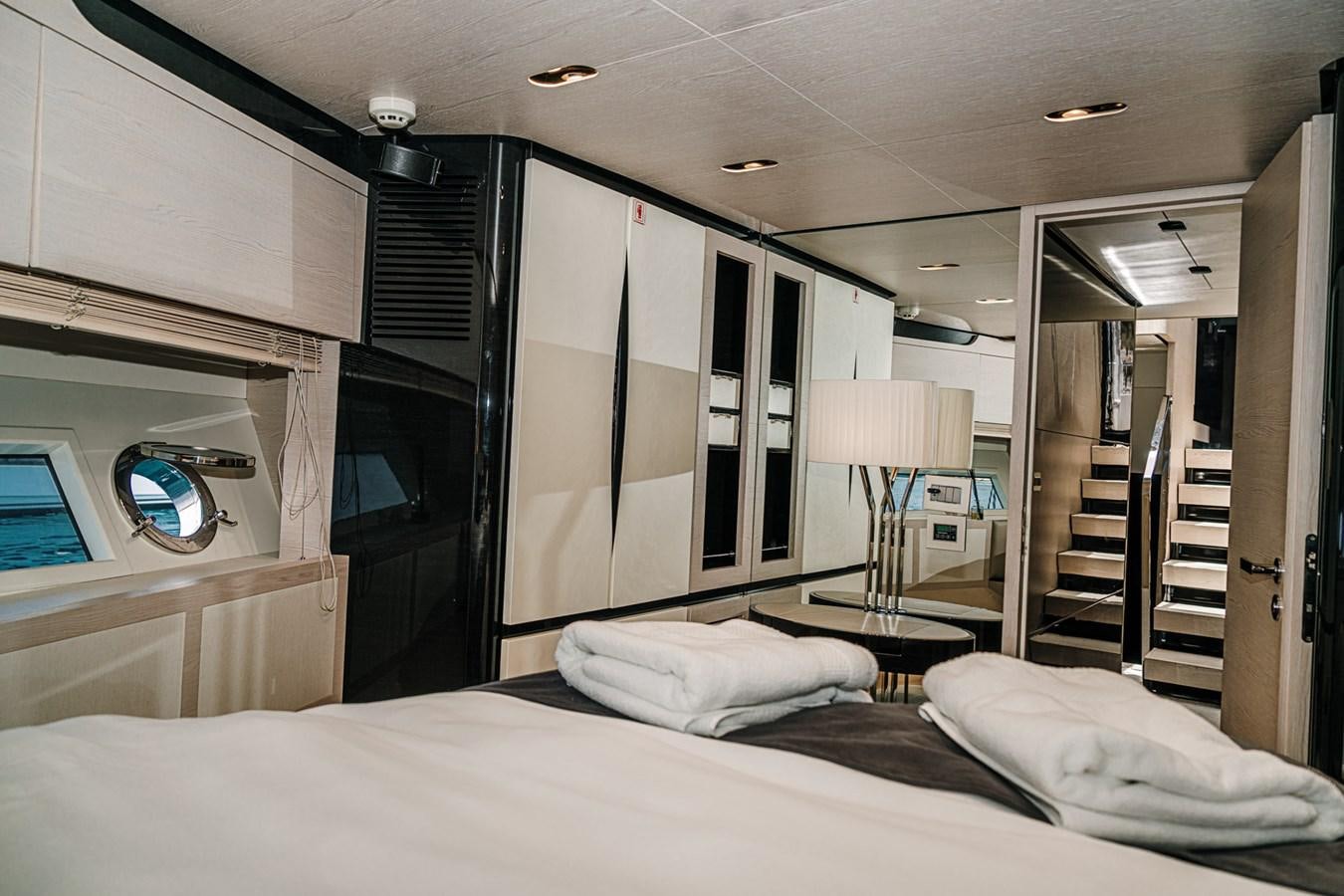 a bedroom with a bed and a ladder aboard AZIMUT 88 DELETE Yacht for Sale