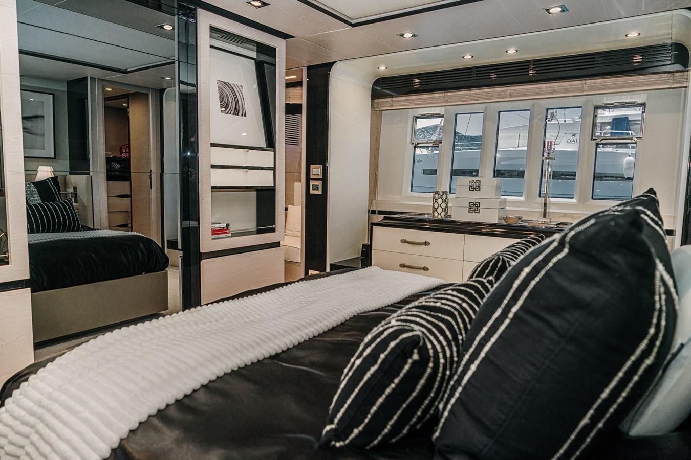 a room with a bed and a desk aboard AZIMUT 88 DELETE Yacht for Sale