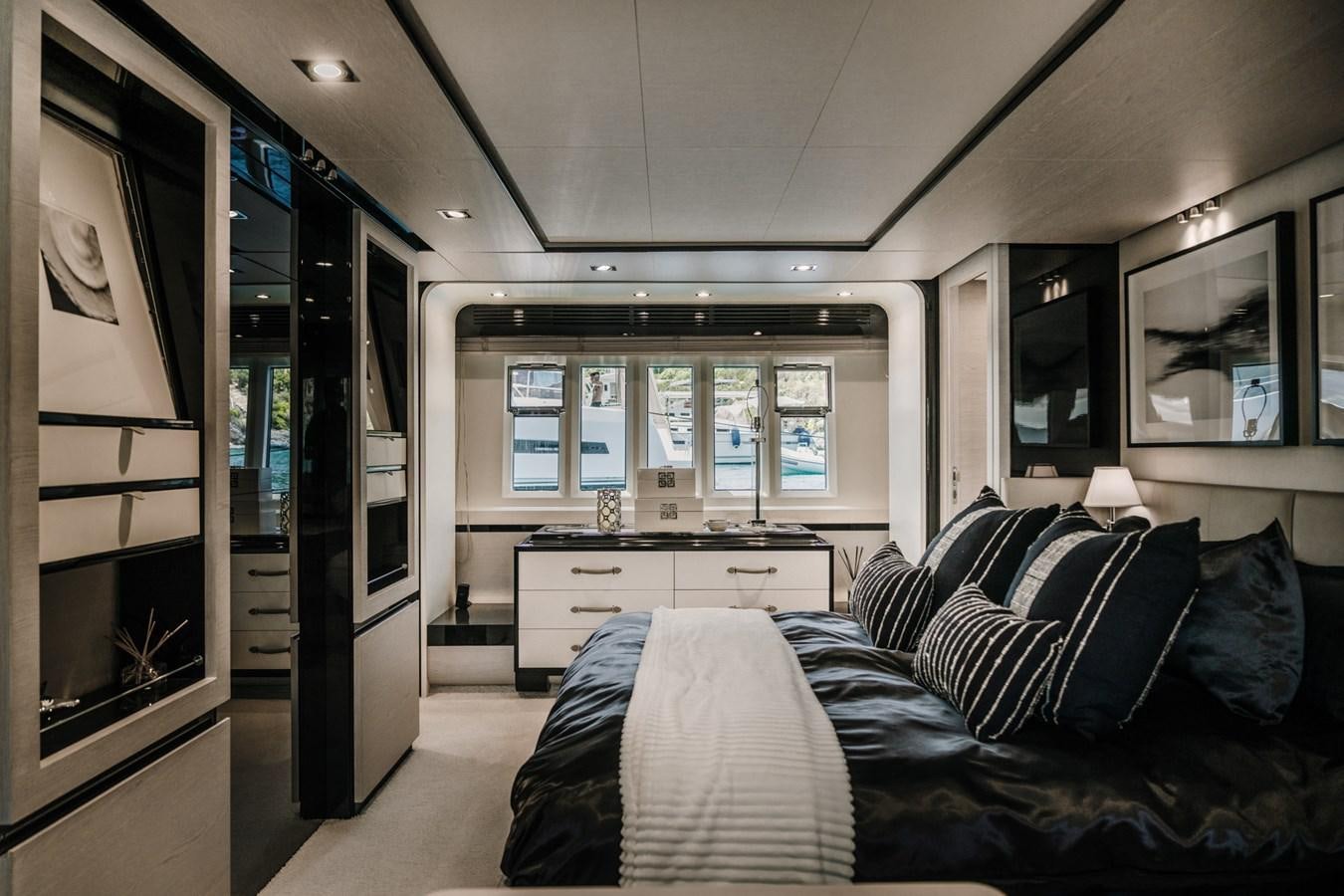a bedroom with a bed and desk aboard AZIMUT 88 DELETE Yacht for Sale
