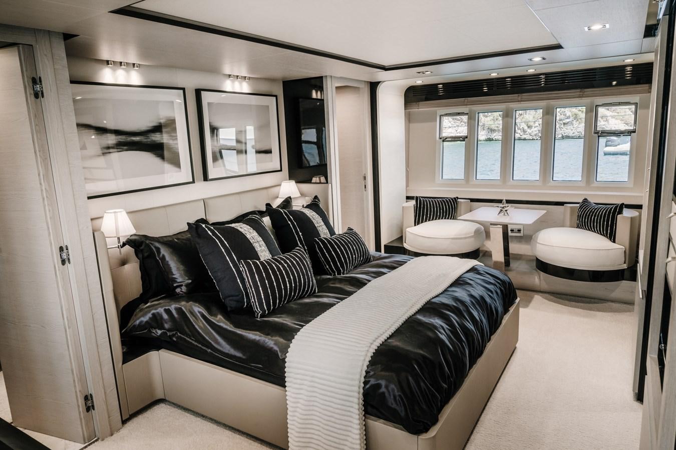 a bedroom with a bed and a table aboard AZIMUT 88 DELETE Yacht for Sale