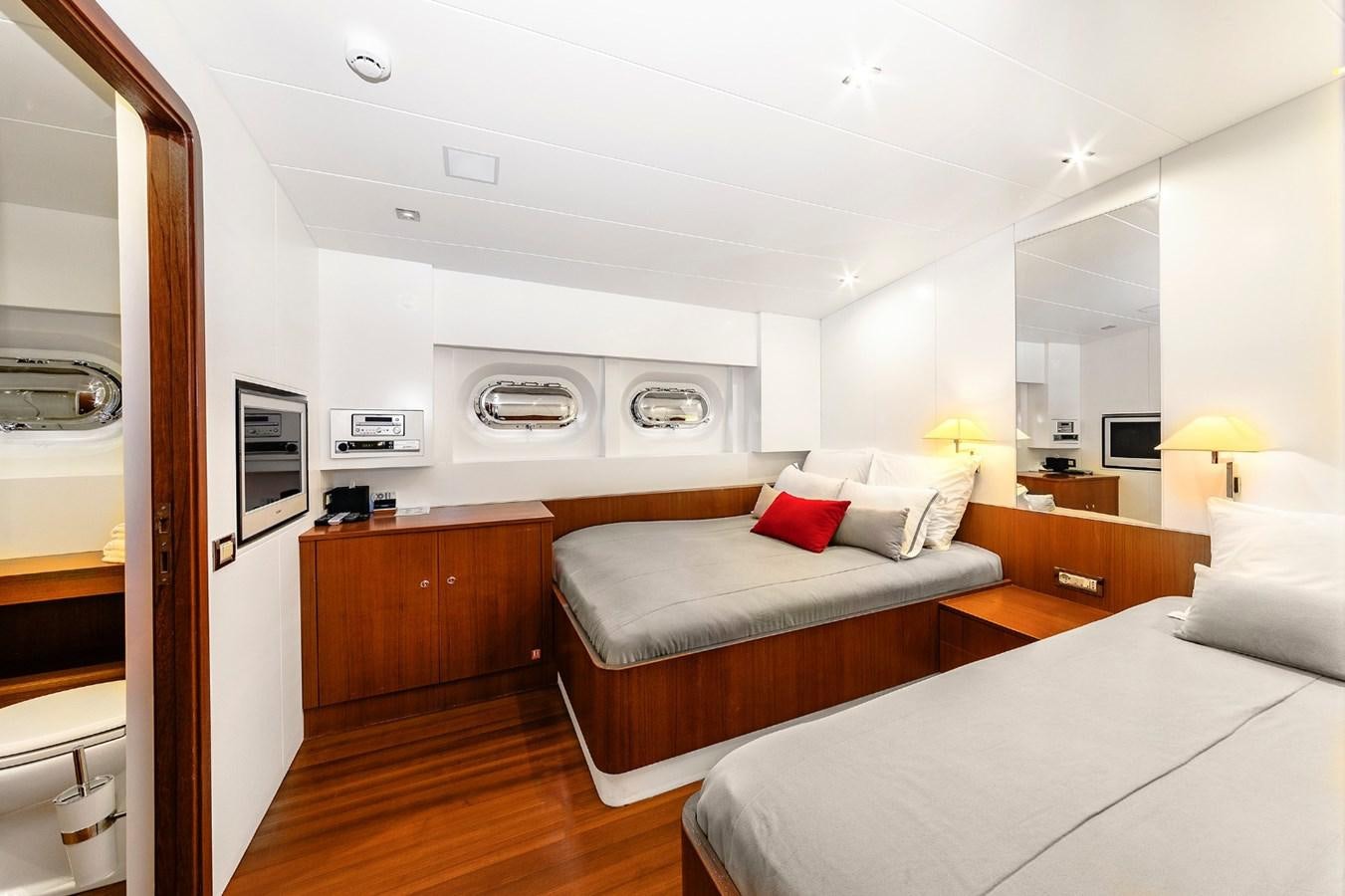a bedroom with a bed and a desk aboard UBI BENE Yacht for Sale
