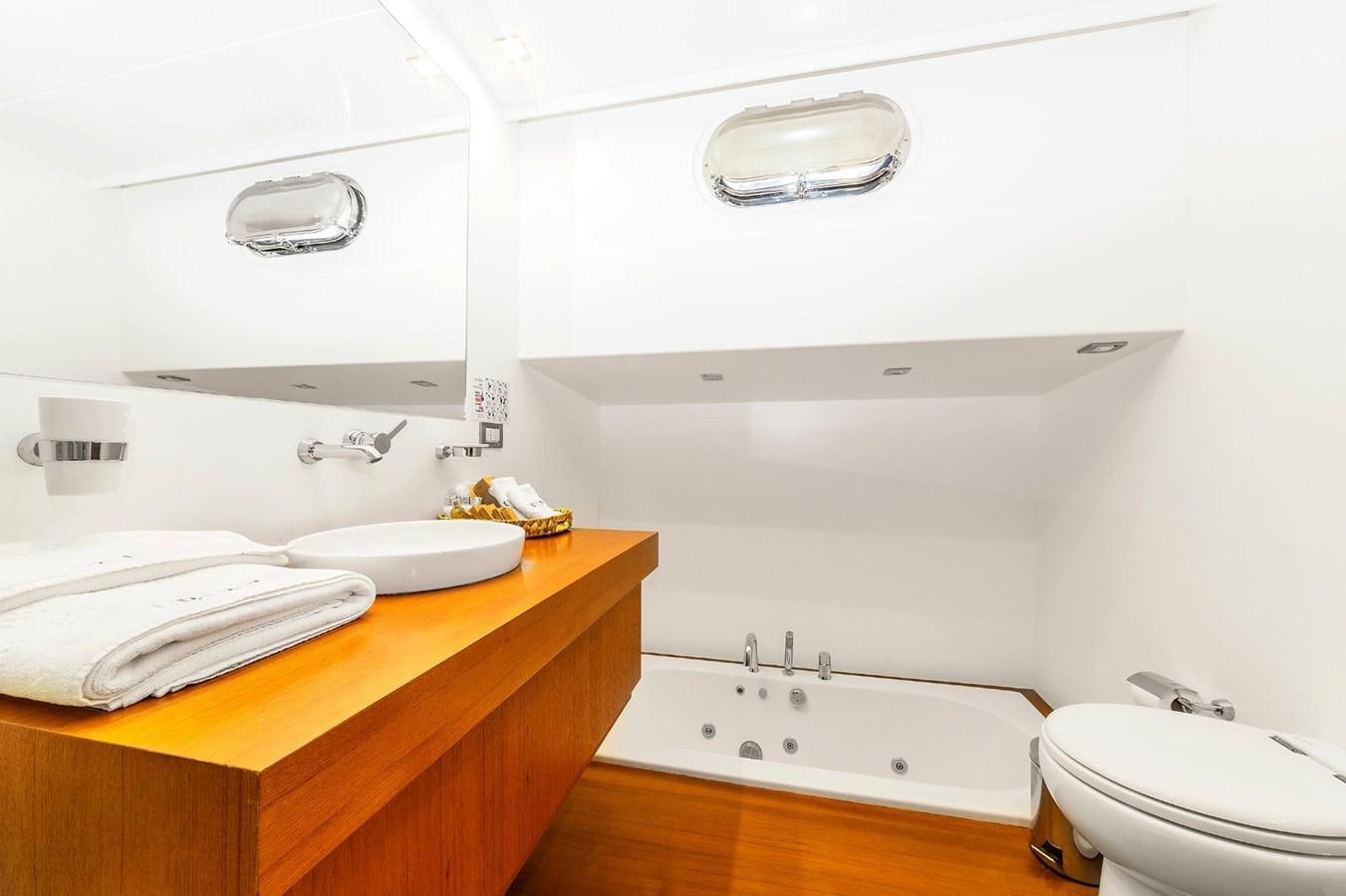 a bathroom with a toilet sink and a mirror aboard UBI BENE Yacht for Sale