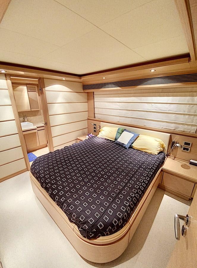 a bed with a black and white blanket on it aboard THIRTEEN Yacht for Sale