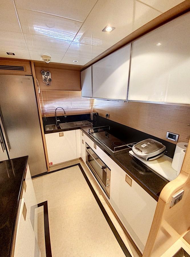 a kitchen with a stove and a sink aboard THIRTEEN Yacht for Sale