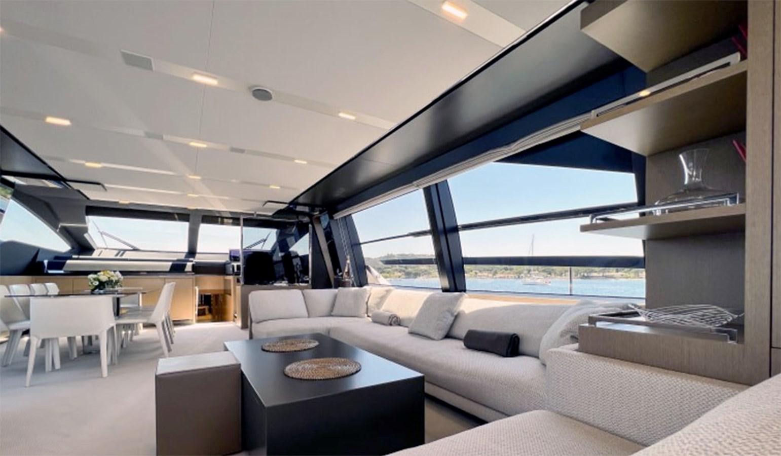 a room with a couch and a table and a view of the water aboard KAR Yacht for Sale