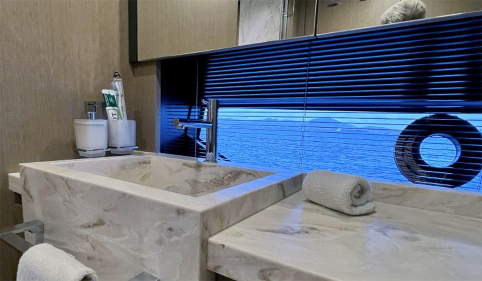 a bathtub with a sink and a window aboard KAR Yacht for Sale