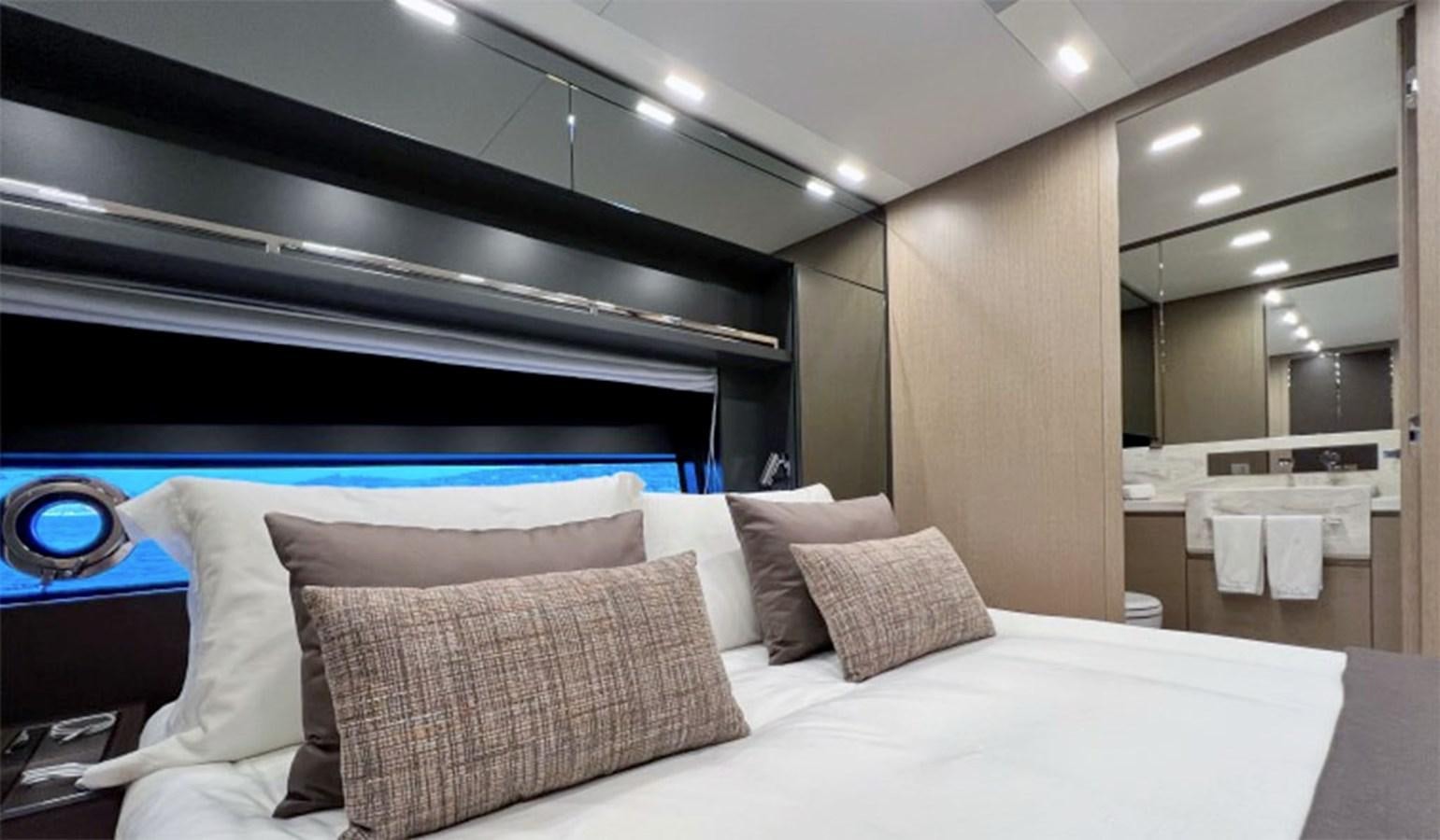 a room with a bed and a mirror aboard KAR Yacht for Sale