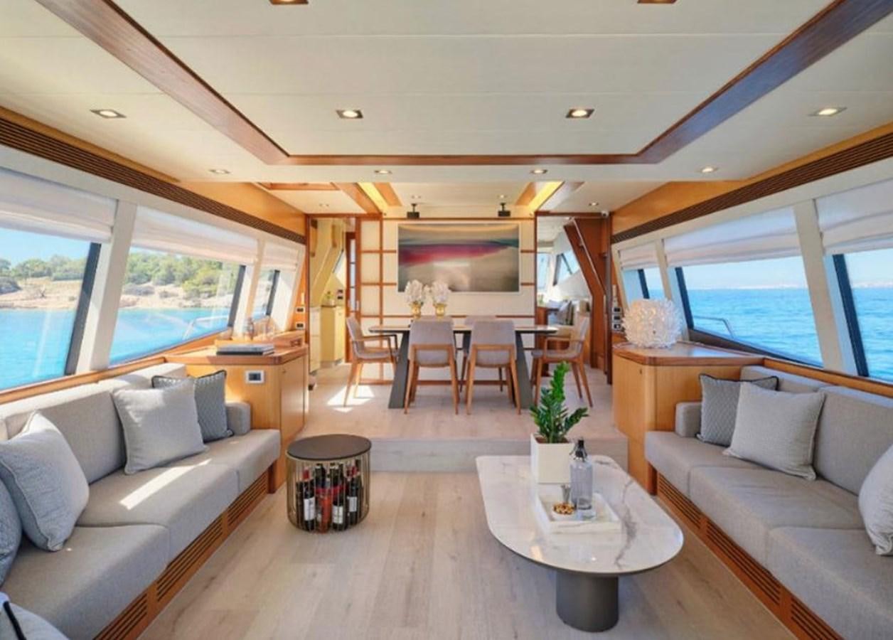 a living room with a couch and a table aboard 731 Yacht for Sale