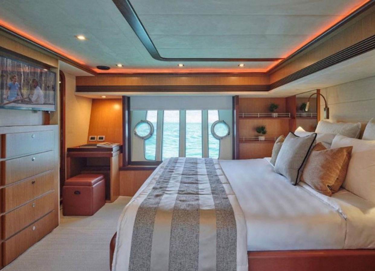 a bedroom with a bed and a dresser aboard 731 Yacht for Sale