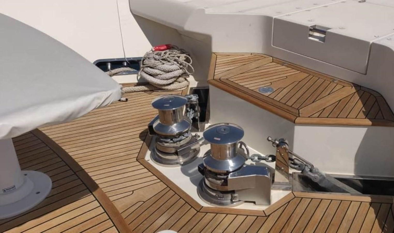 a kitchen with a stove and a wood shelf aboard NAVETTA 28 Yacht for Sale