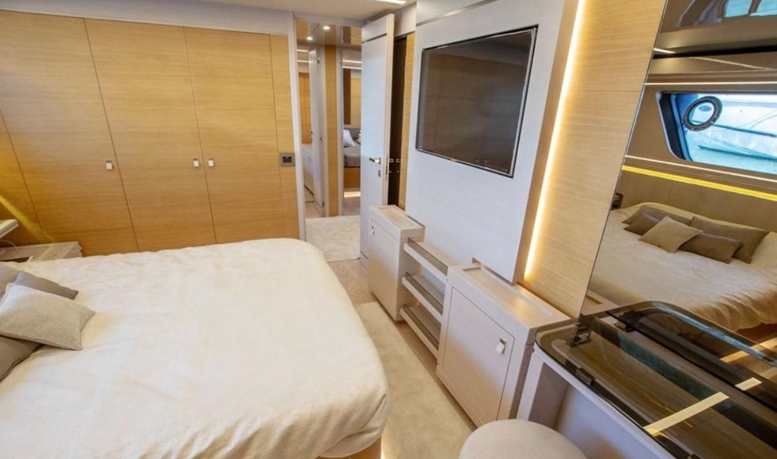 a room with a bed and a television aboard NAVETTA 28 Yacht for Sale