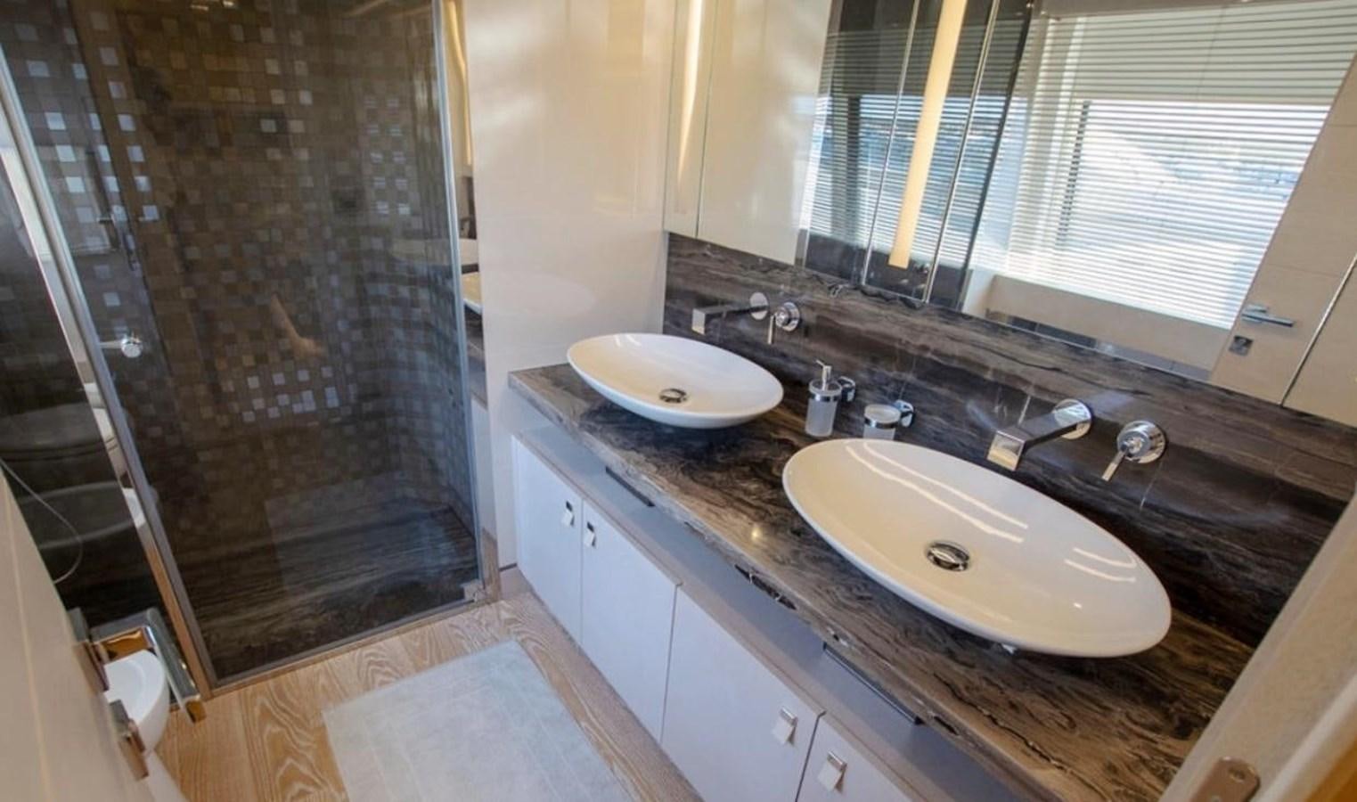 a bathroom with a sink and a shower aboard NAVETTA 28 Yacht for Sale