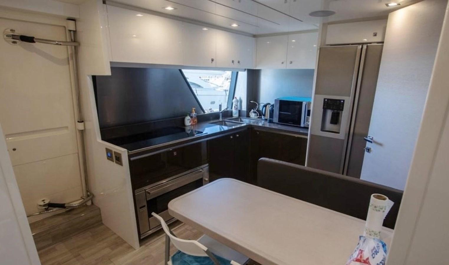 a kitchen with a white table aboard NAVETTA 28 Yacht for Sale