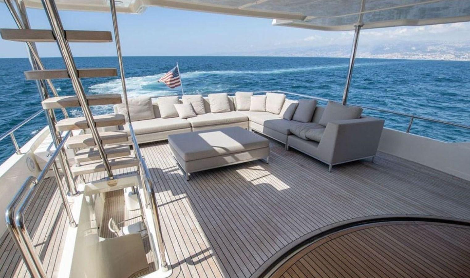 a deck with a couch and a flag on it aboard NAVETTA 28 Yacht for Sale