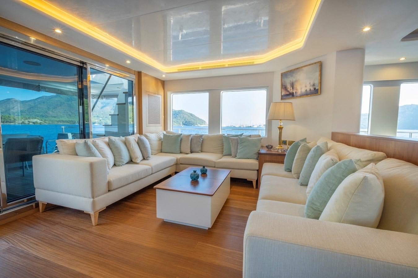 a living room with a large window aboard MURAL 85 Yacht for Sale