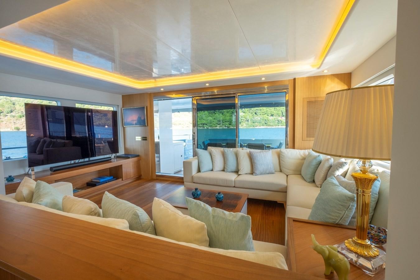 a living room with a large window aboard MURAL 85 Yacht for Sale
