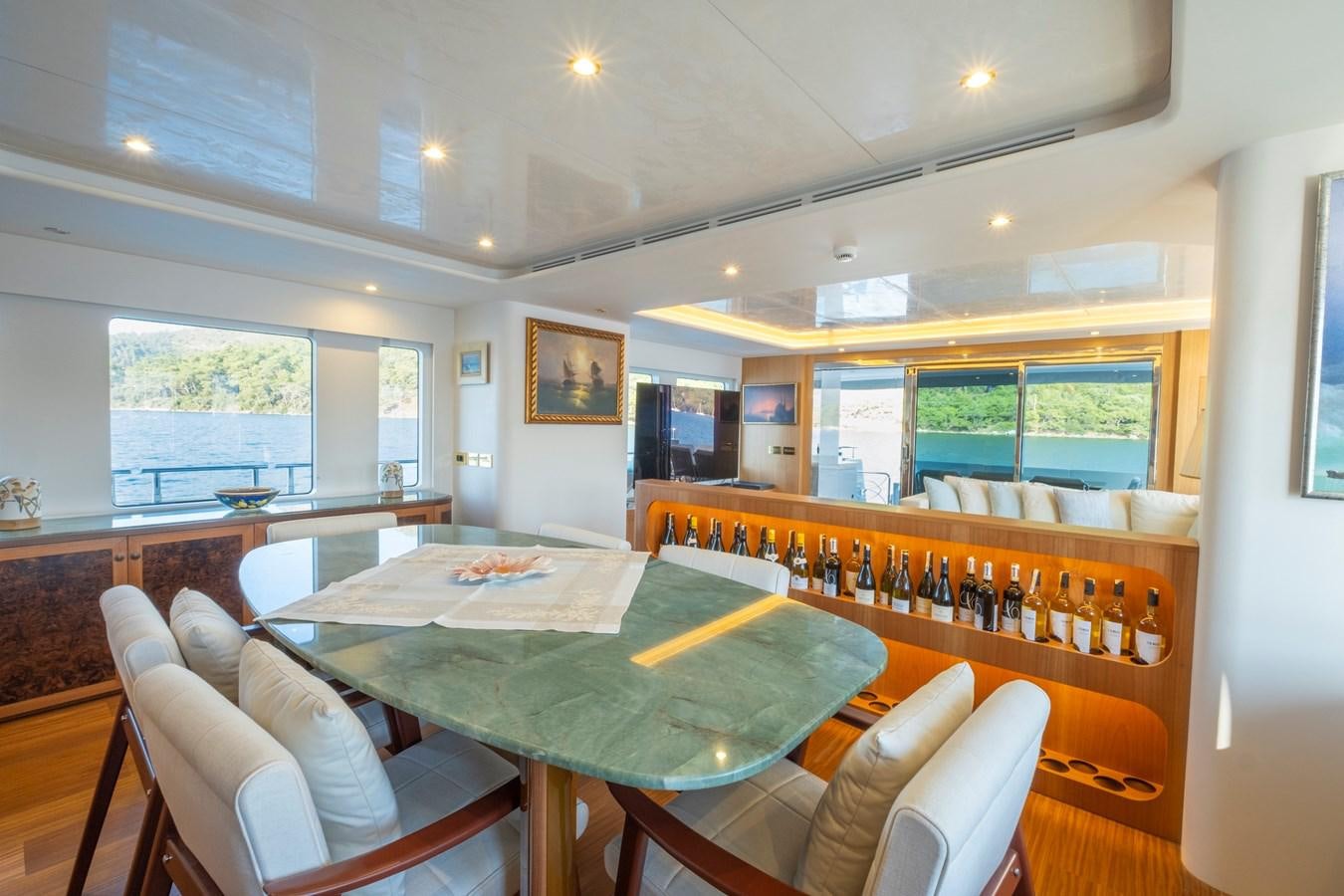 a room with a table and chairs aboard MURAL 85 Yacht for Sale