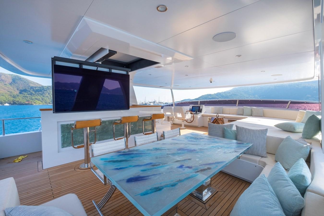 a large living room with a large screen aboard MURAL 85 Yacht for Sale