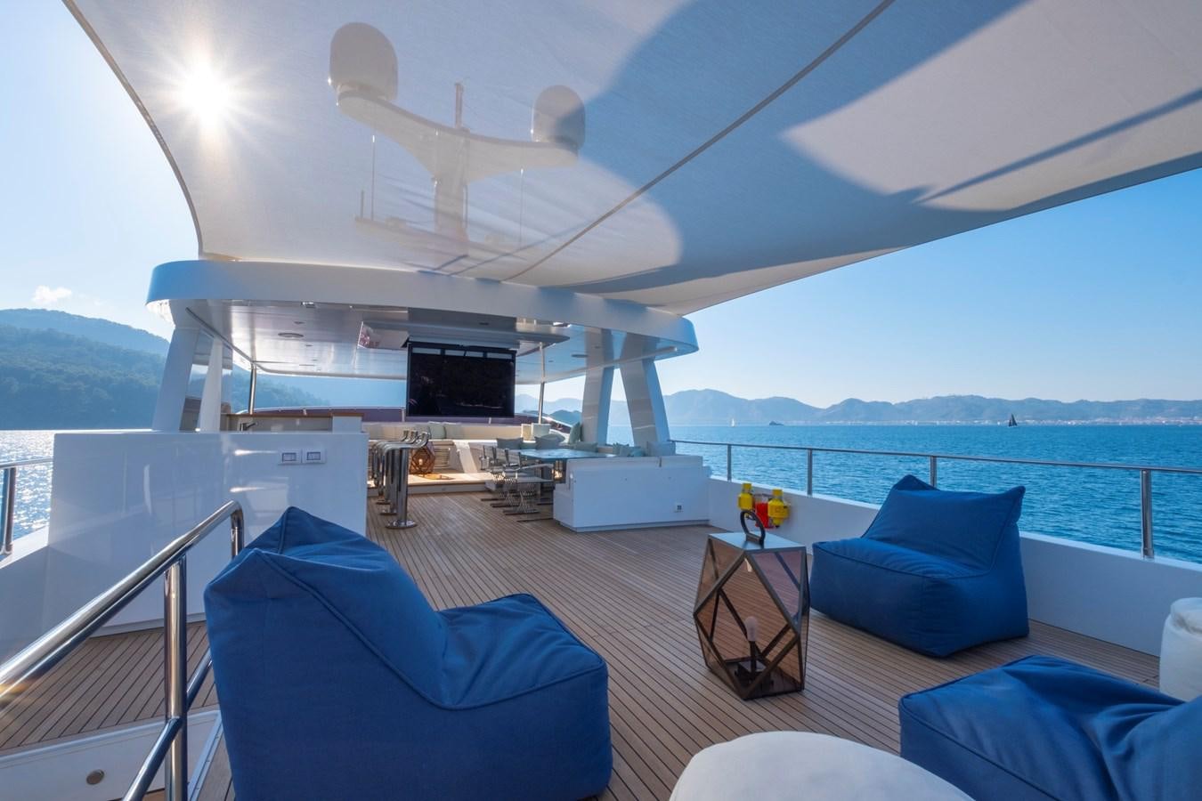 a large living room with a large balcony overlooking the ocean aboard MURAL 85 Yacht for Sale