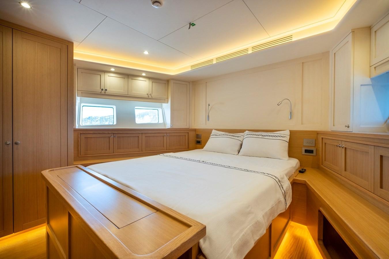 a room with a bed and a desk aboard MURAL 85 Yacht for Sale