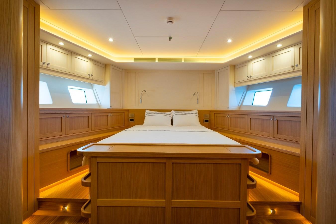 a large room with a bed and cabinets aboard MURAL 85 Yacht for Sale