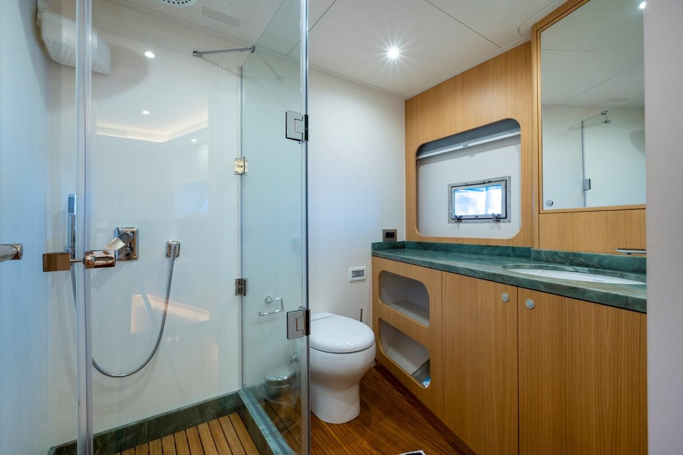 a bathroom with a glass shower aboard MURAL 85 Yacht for Sale