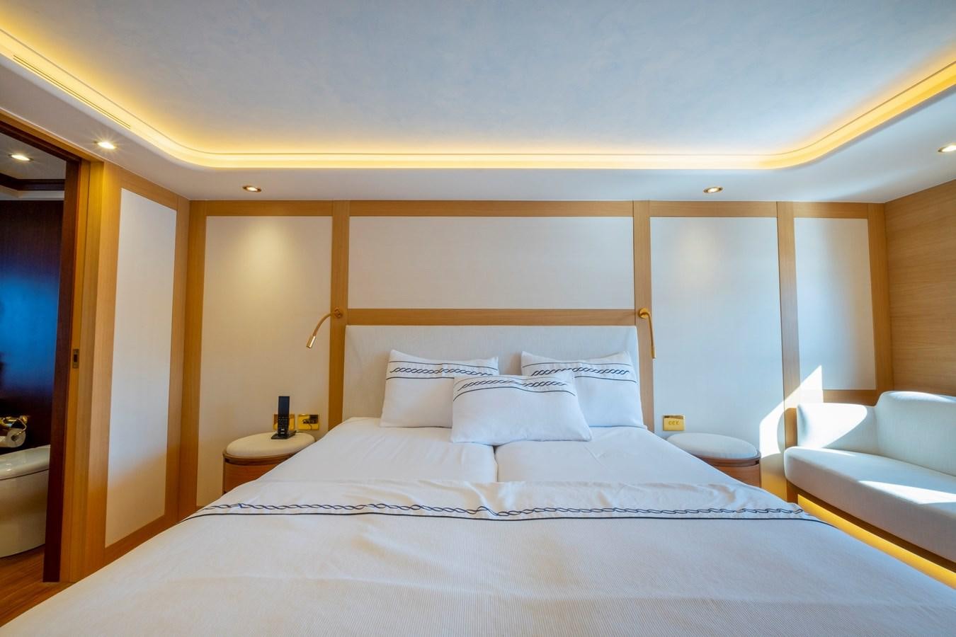 a large bed with white sheets aboard MURAL 85 Yacht for Sale