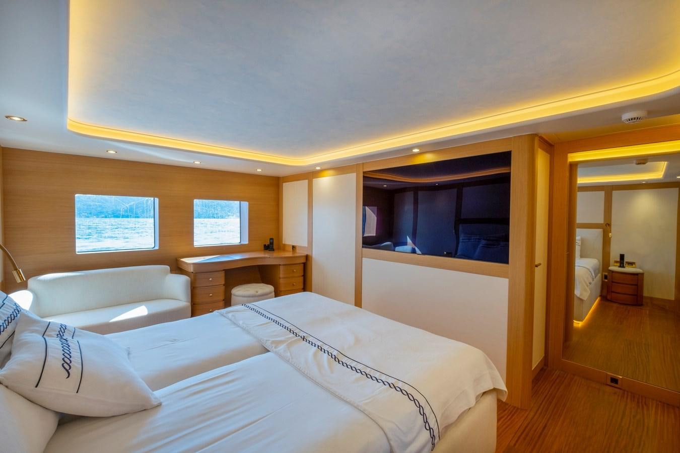 a room with a bed and a desk aboard MURAL 85 Yacht for Sale