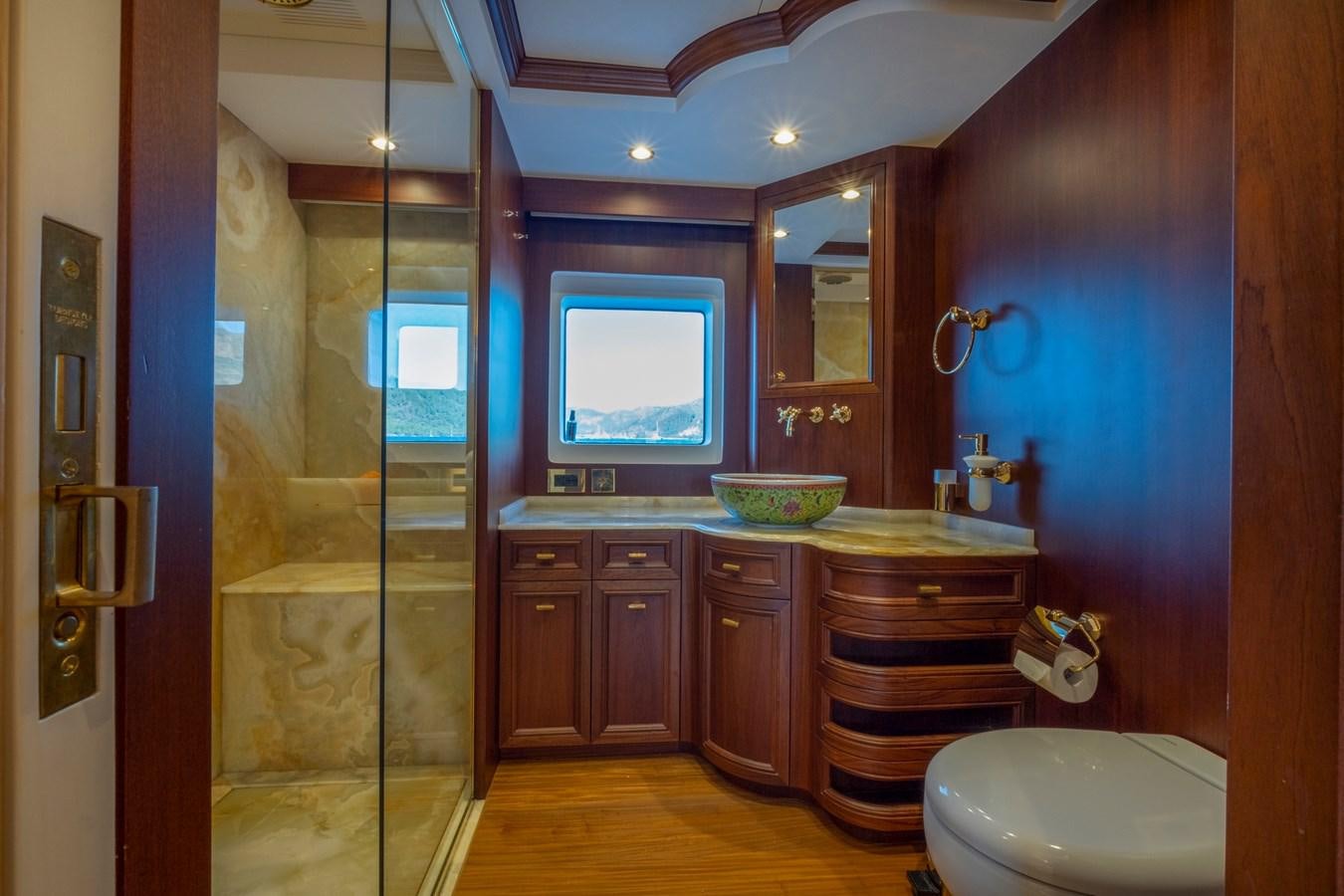 a bathroom with a glass shower door aboard MURAL 85 Yacht for Sale