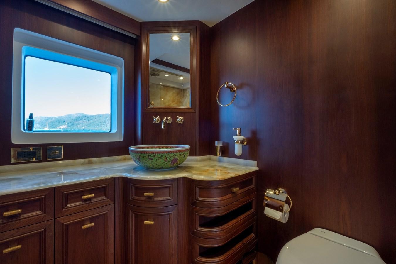 a bathroom with a sink and a mirror aboard MURAL 85 Yacht for Sale