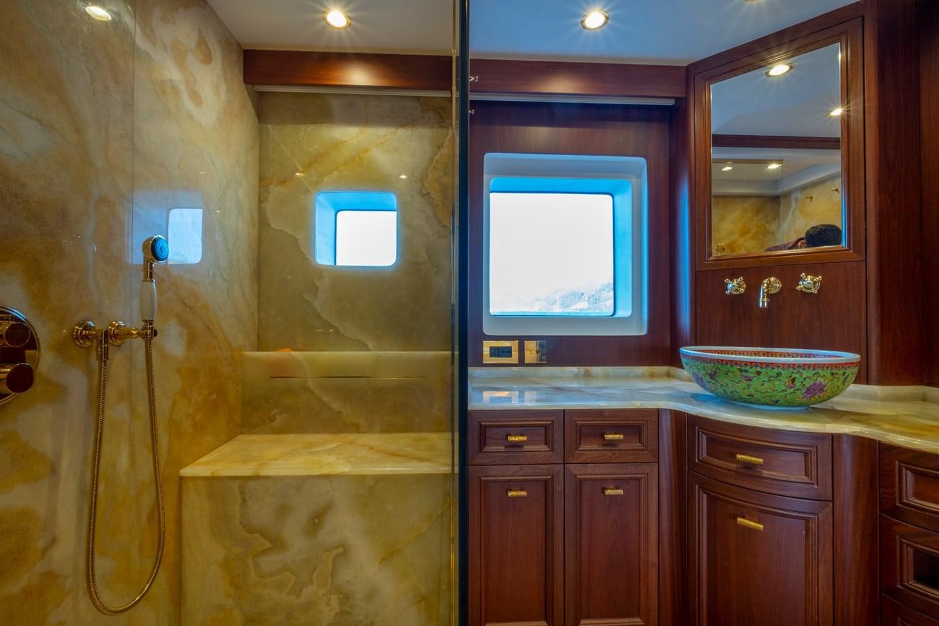 a bathroom with a sink and a mirror aboard MURAL 85 Yacht for Sale