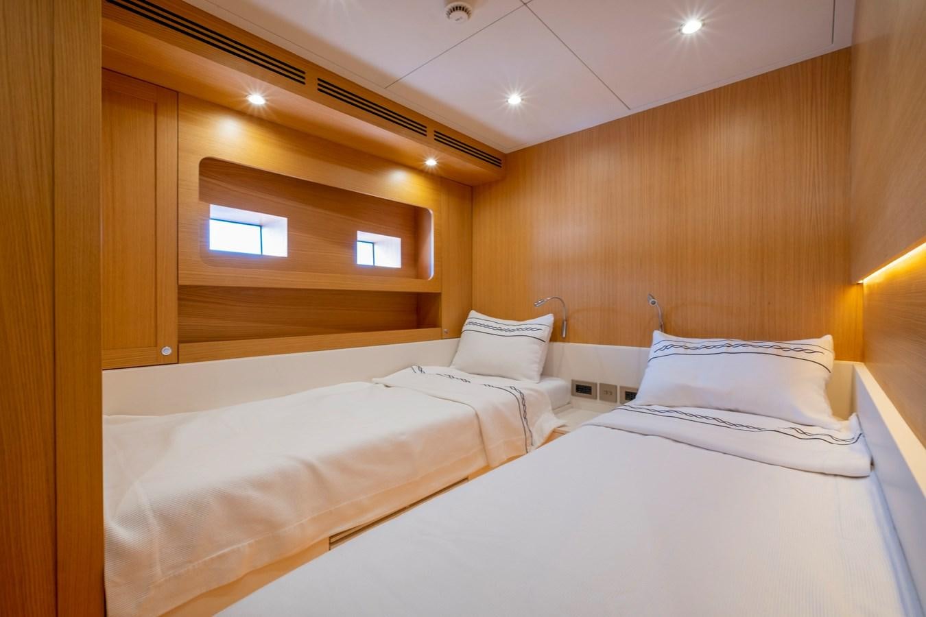 a room with two beds aboard MURAL 85 Yacht for Sale
