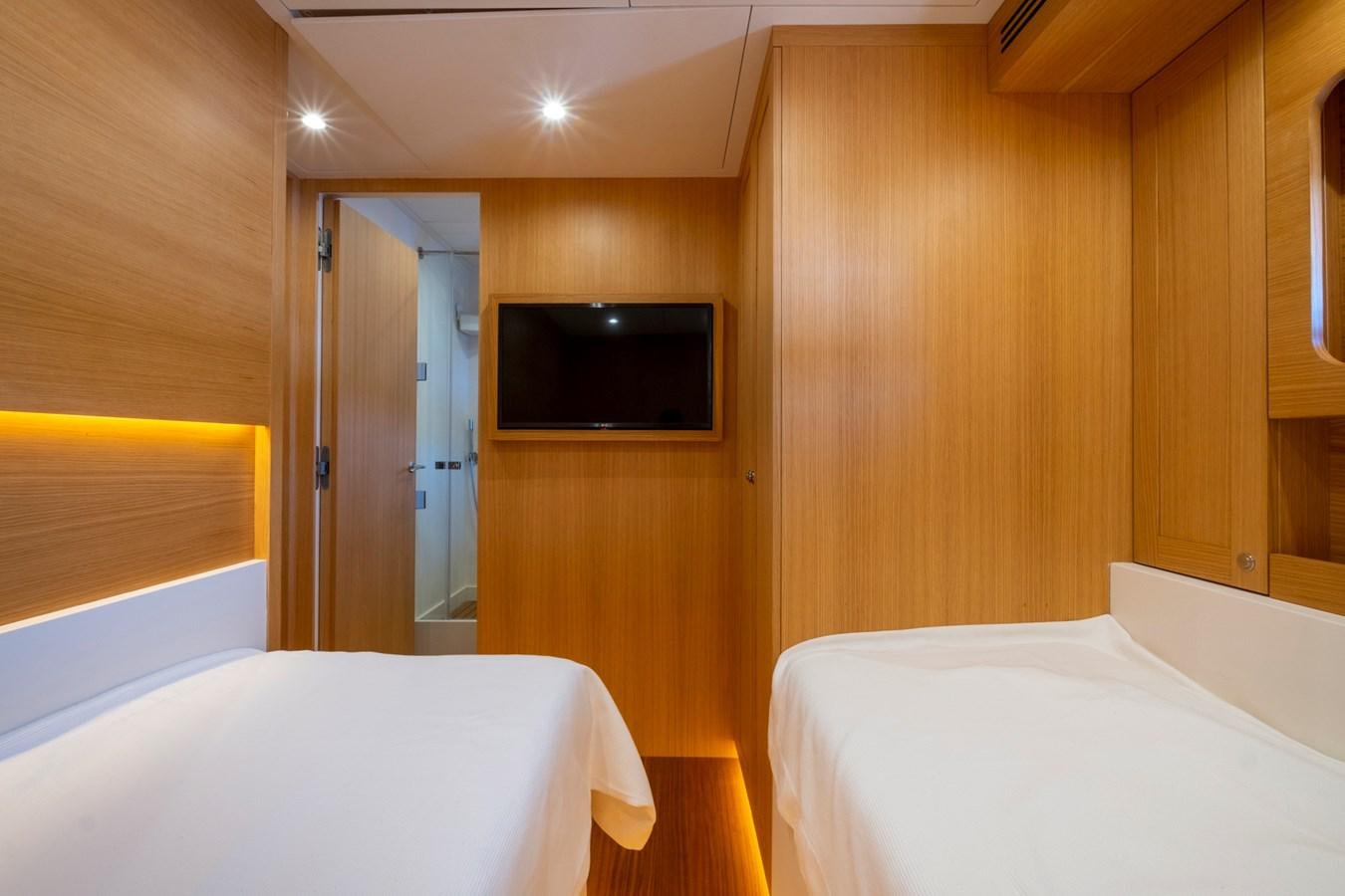 a room with a bed and a television aboard MURAL 85 Yacht for Sale
