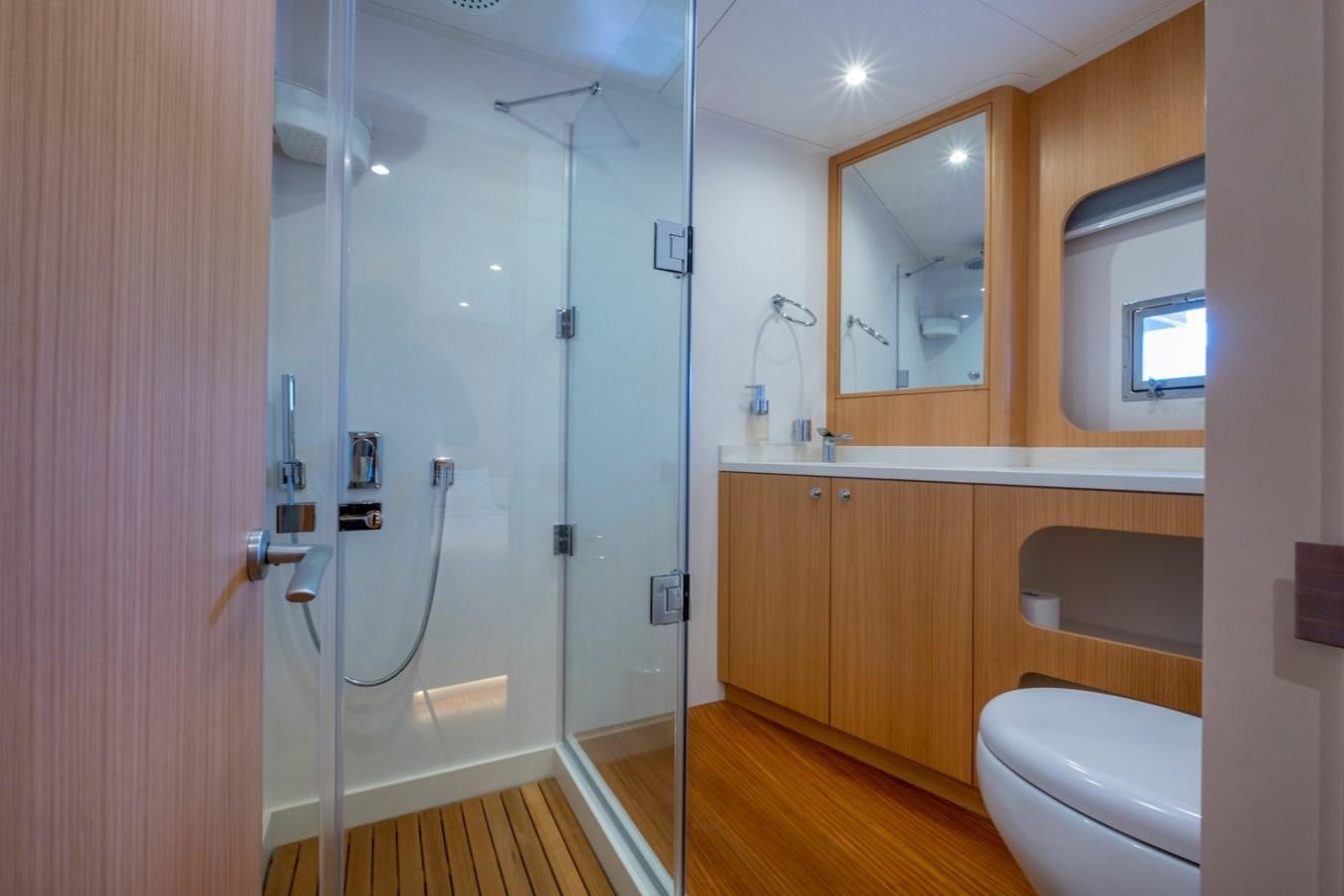 a bathroom with a shower and toilet aboard MURAL 85 Yacht for Sale