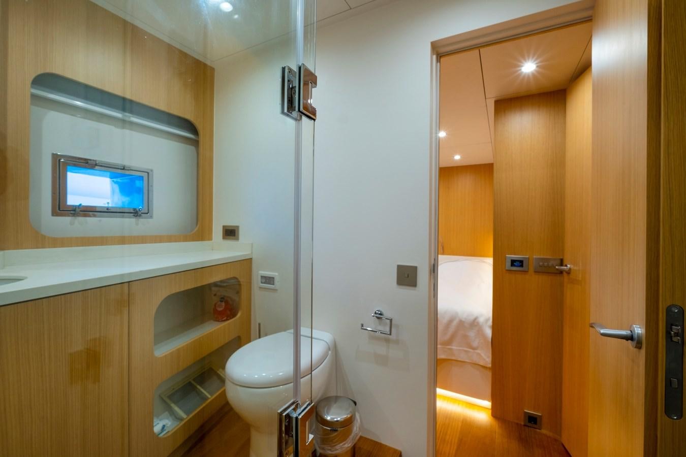 a bathroom with a toilet and a sink aboard MURAL 85 Yacht for Sale