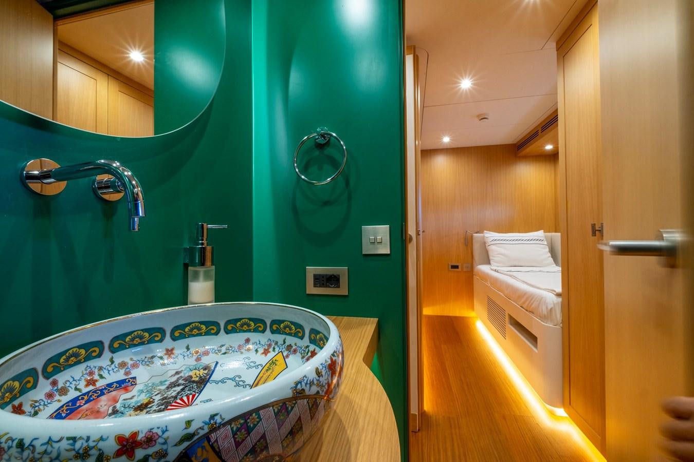 a bathroom with a bed and a bathtub aboard MURAL 85 Yacht for Sale